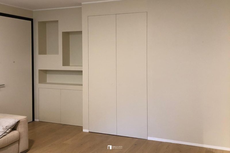 Invisible two-door wardrobe used as a coat rack